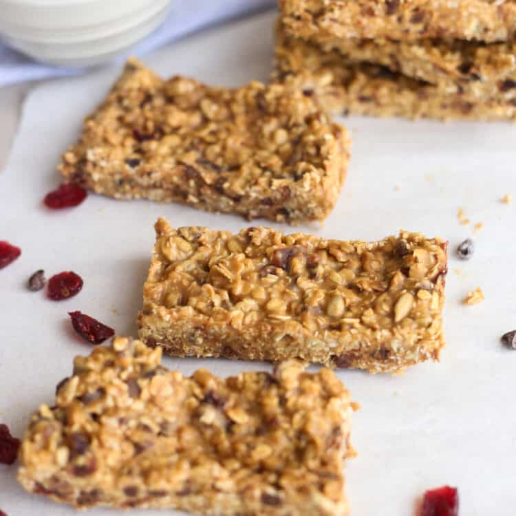 peanut butter protein bars laid out on parchment paper.