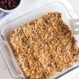 Homemade peanut butter protein bars in a glass dish sliced and ready to be wrapped individually.