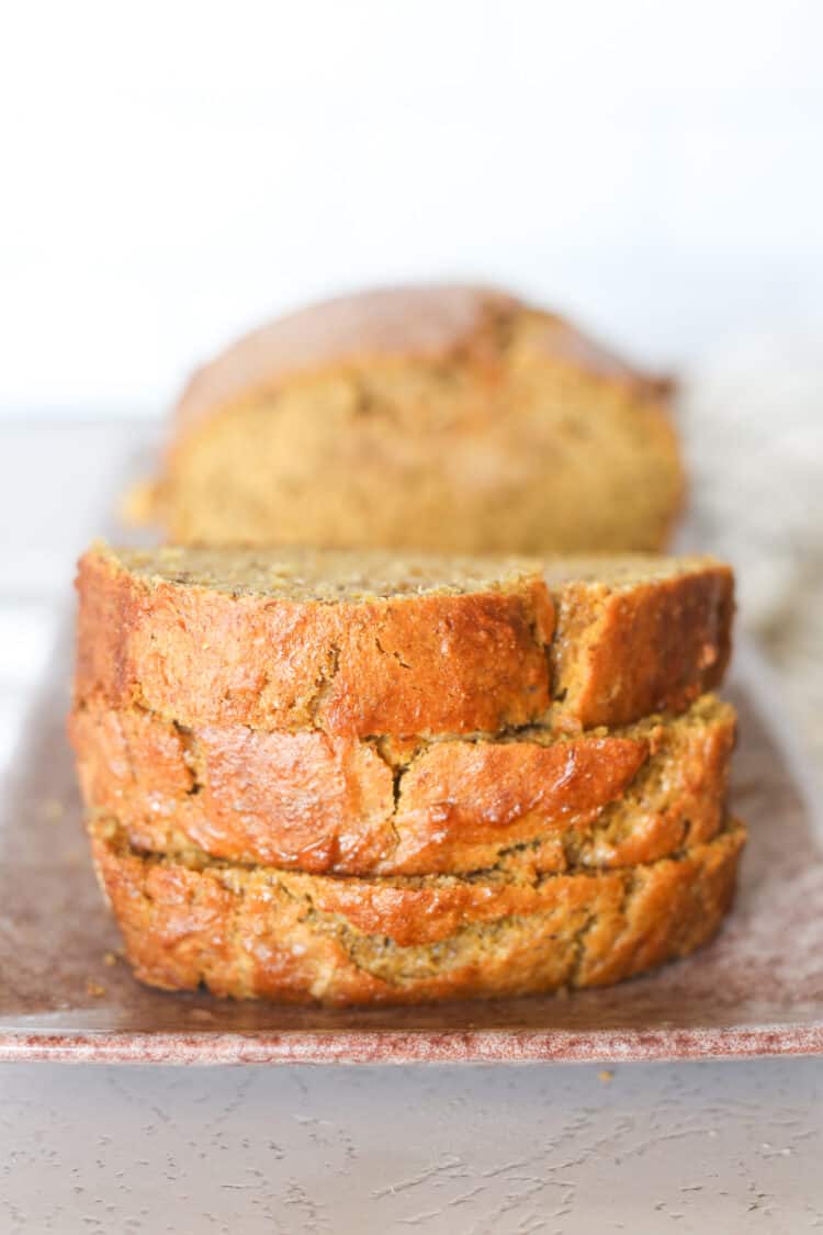 Three slices of banana pumpkin bread stacked.