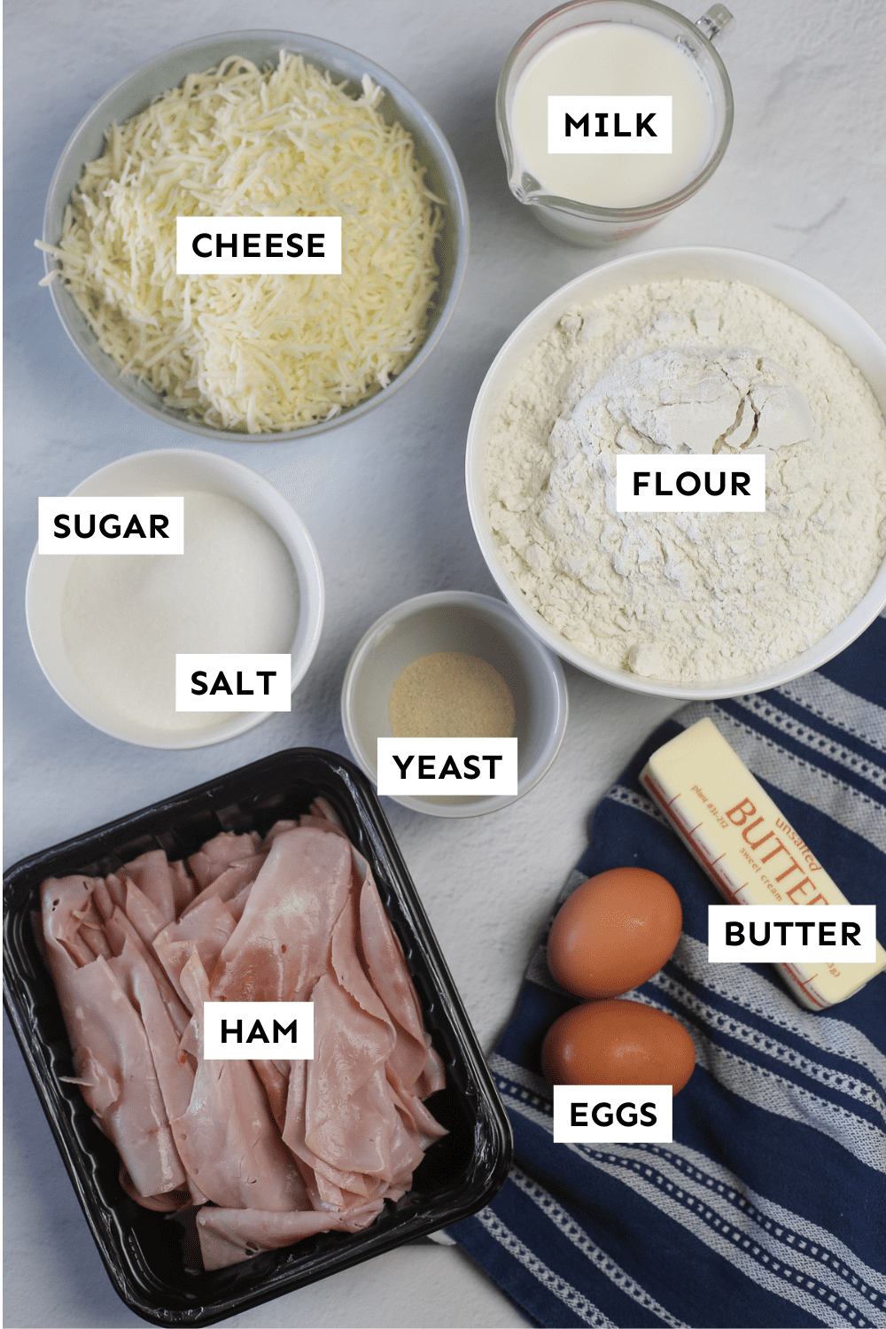 Ham and cheese crescent roll ingredients measured out in bowls with labels.