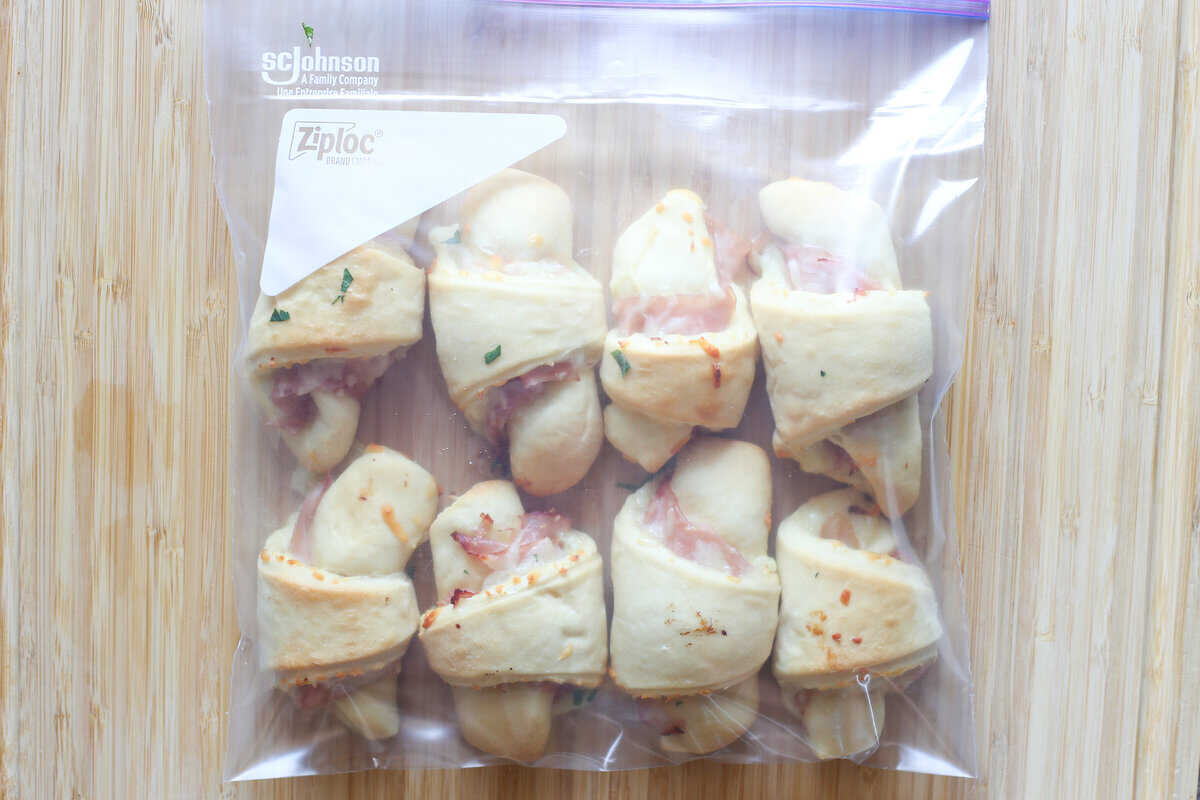 Ham and cheese croissants in a plastic bag ready for the freezer.