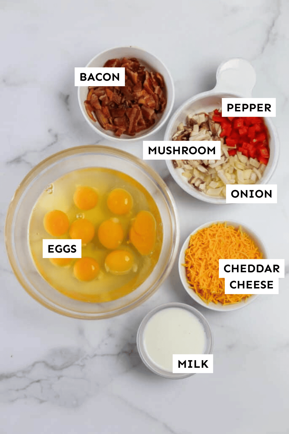 Baked omelette ingredients measured in bowls and laid out on a counter.