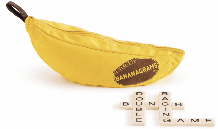 Bananagrams game with some of the tiles sitting outside the container.