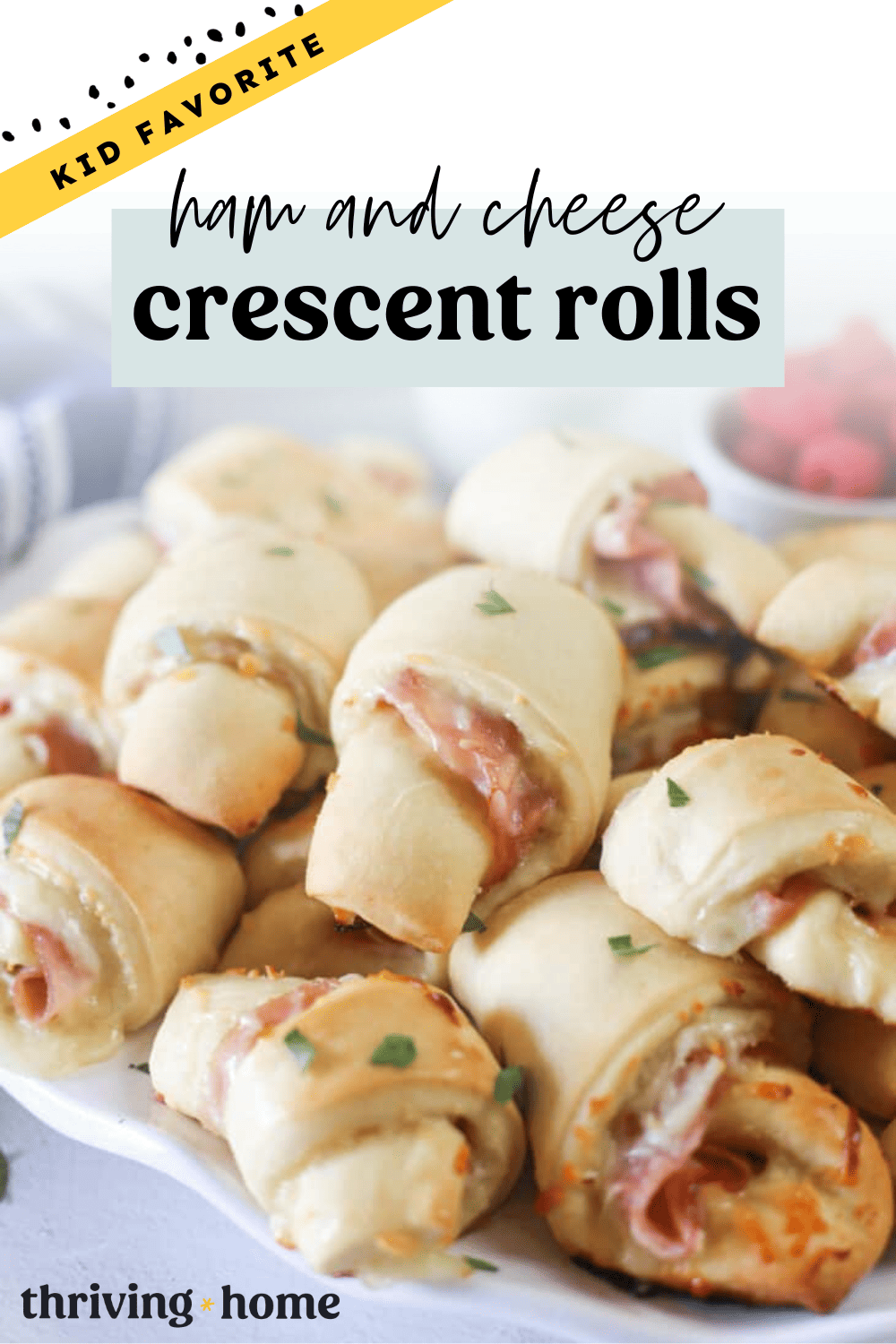 Ham and cheese crescent rolls stacked up on a platter.