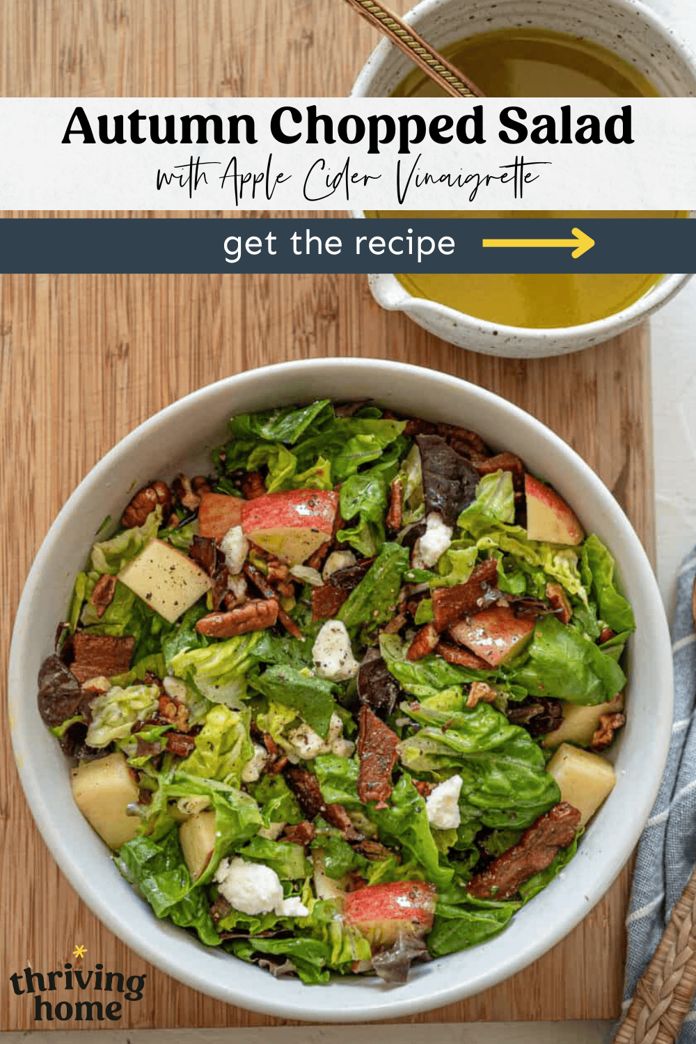 Chopped salad with apples on top in a bowl and dressing on the side.