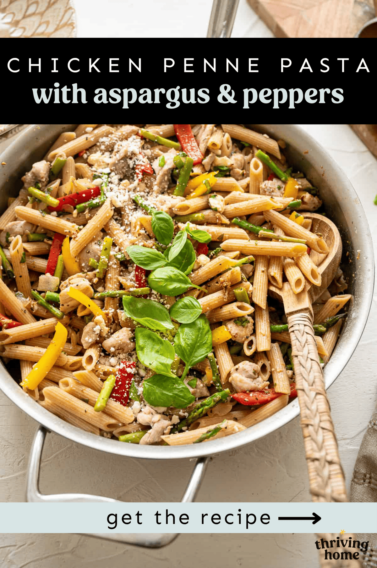 Penne pasta with chicken, asparagus, and red peppers served from a large skillet.