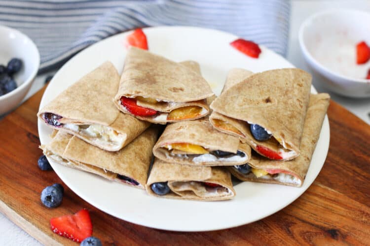 Fruit roll ups stacked up on a plate.