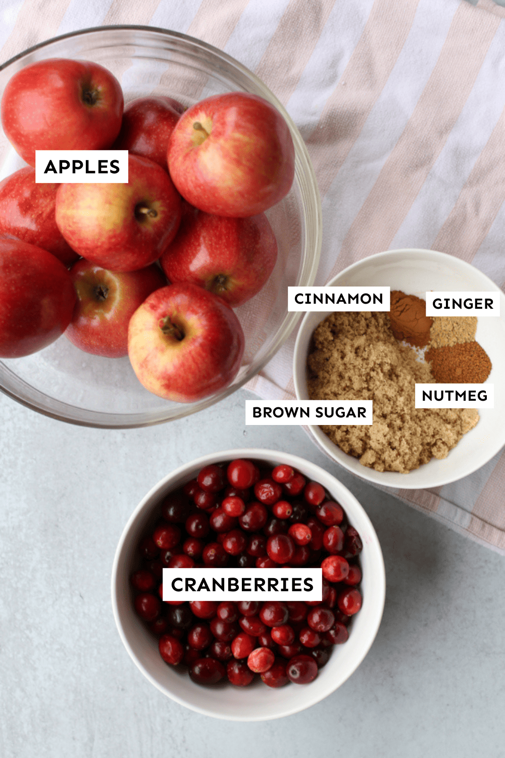 Ingredients for apple cranberry sauce measured and labeled.