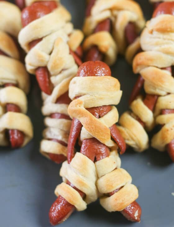 Mummy hot dogs on a plate.