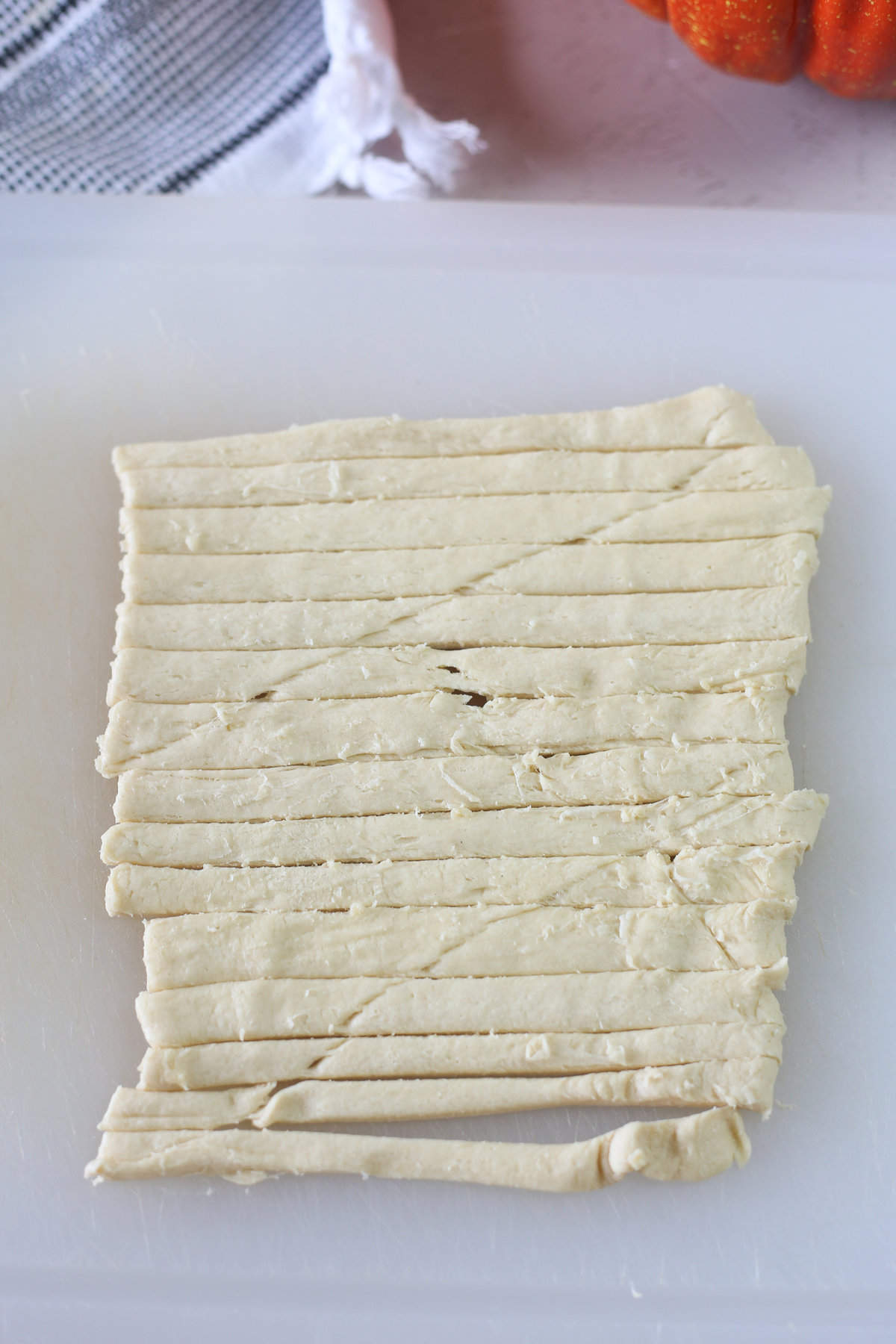 Crescent Roll dough sliced into strips.