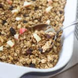 Apple Cinnamon Baked Oatmeal being scooped out of a large dish.
