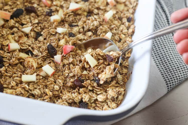 Apple Cinnamon Baked Oatmeal being scooped out of a large dish.