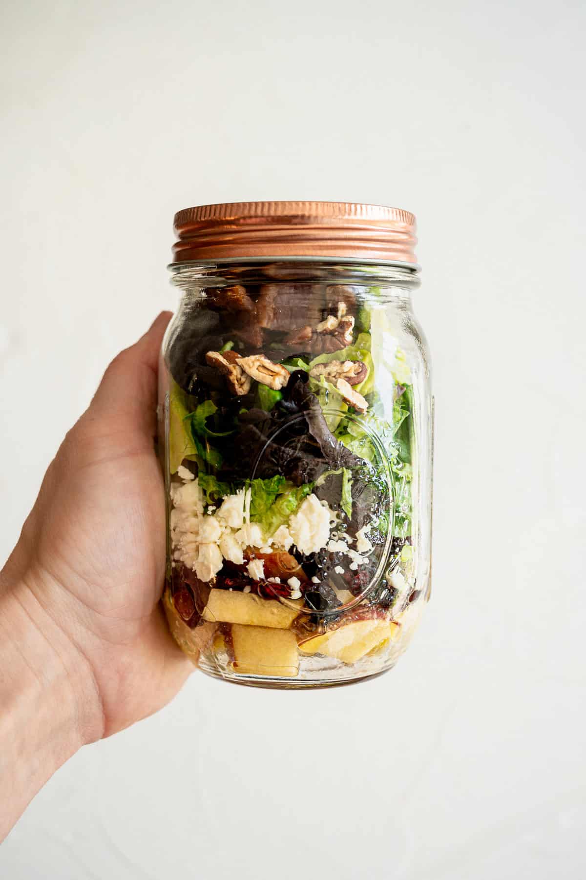 Autumn Salad layered in a mason jar.