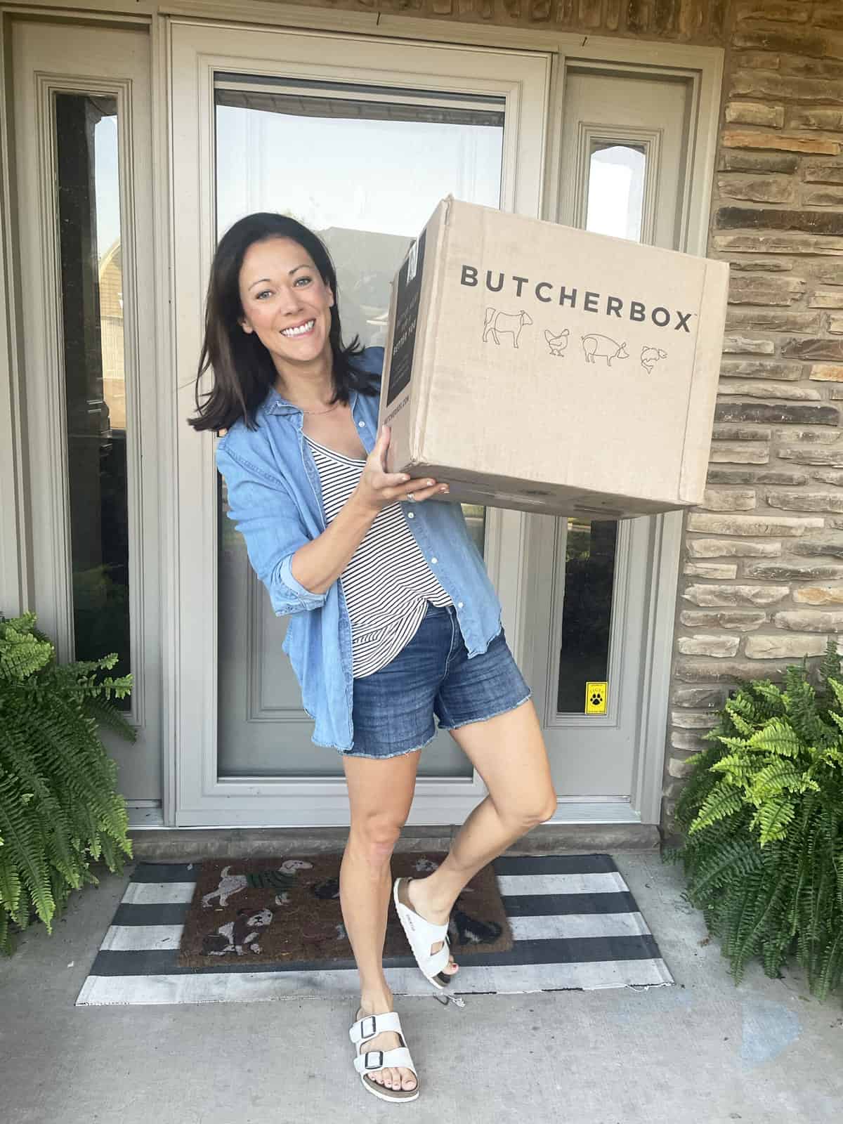 Polly Conner on her front porch holding a butcherbox