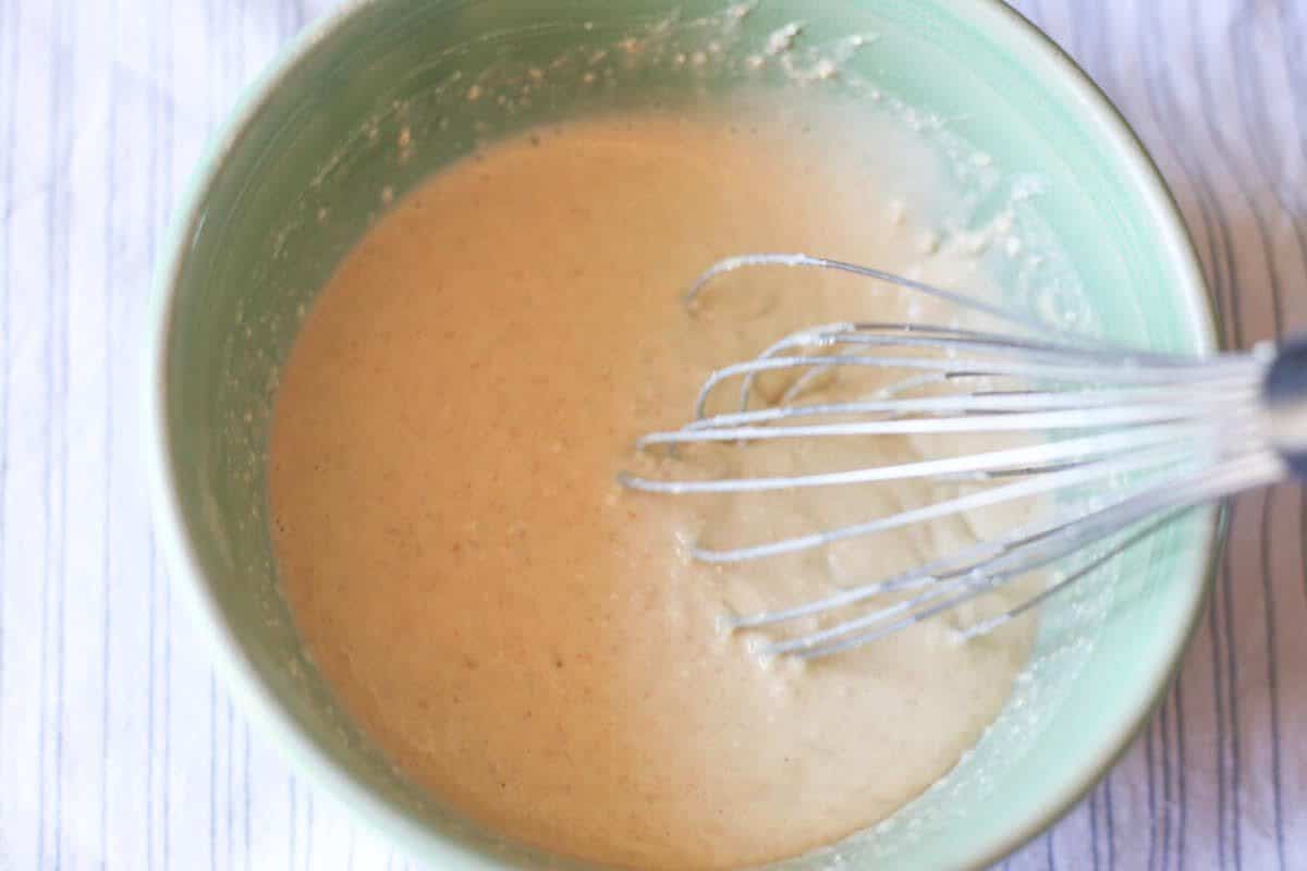 Oatmeal pancake mix being whisked together.