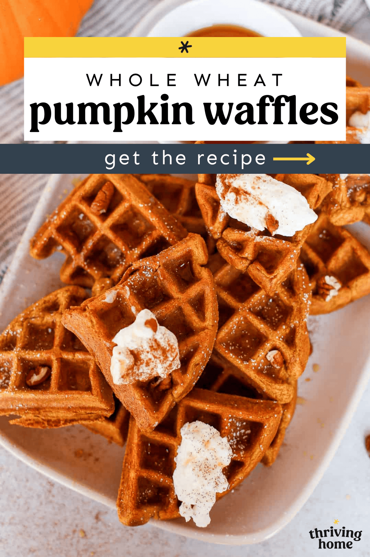 Waffles stacked up on a platter with homemade whipped cream on top.