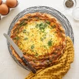 Spinach Bacon Quiche cooked and cooling on a counter top.
