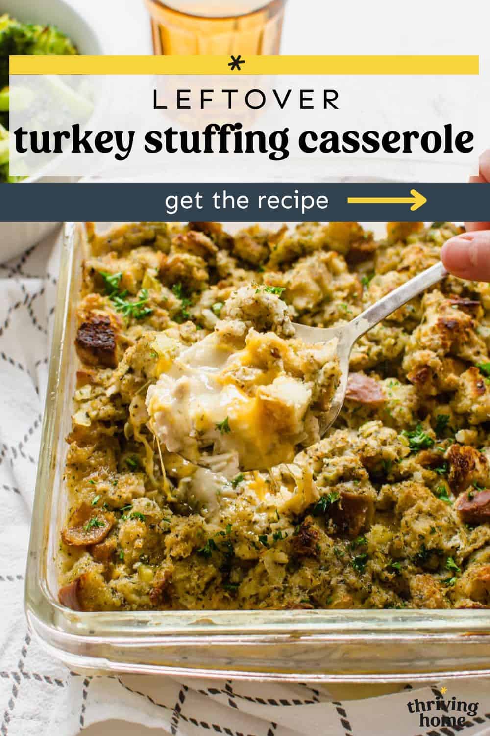 Leftover turkey and stuffing casserole in a dish being spooned out.