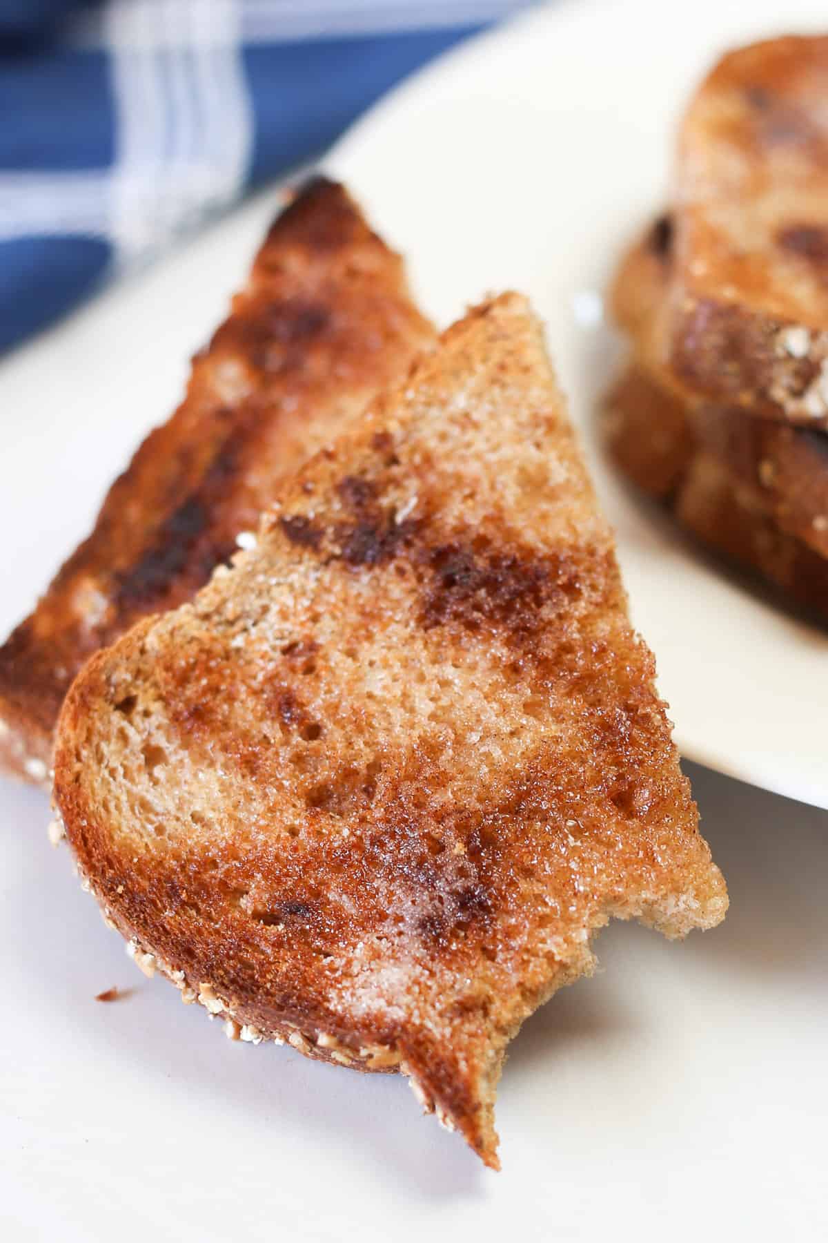 Cinnamon toast made in the oven with a bite taken out of it. 