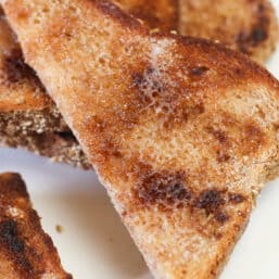 A half slice of cinnamon toast that's been cooked in the oven.