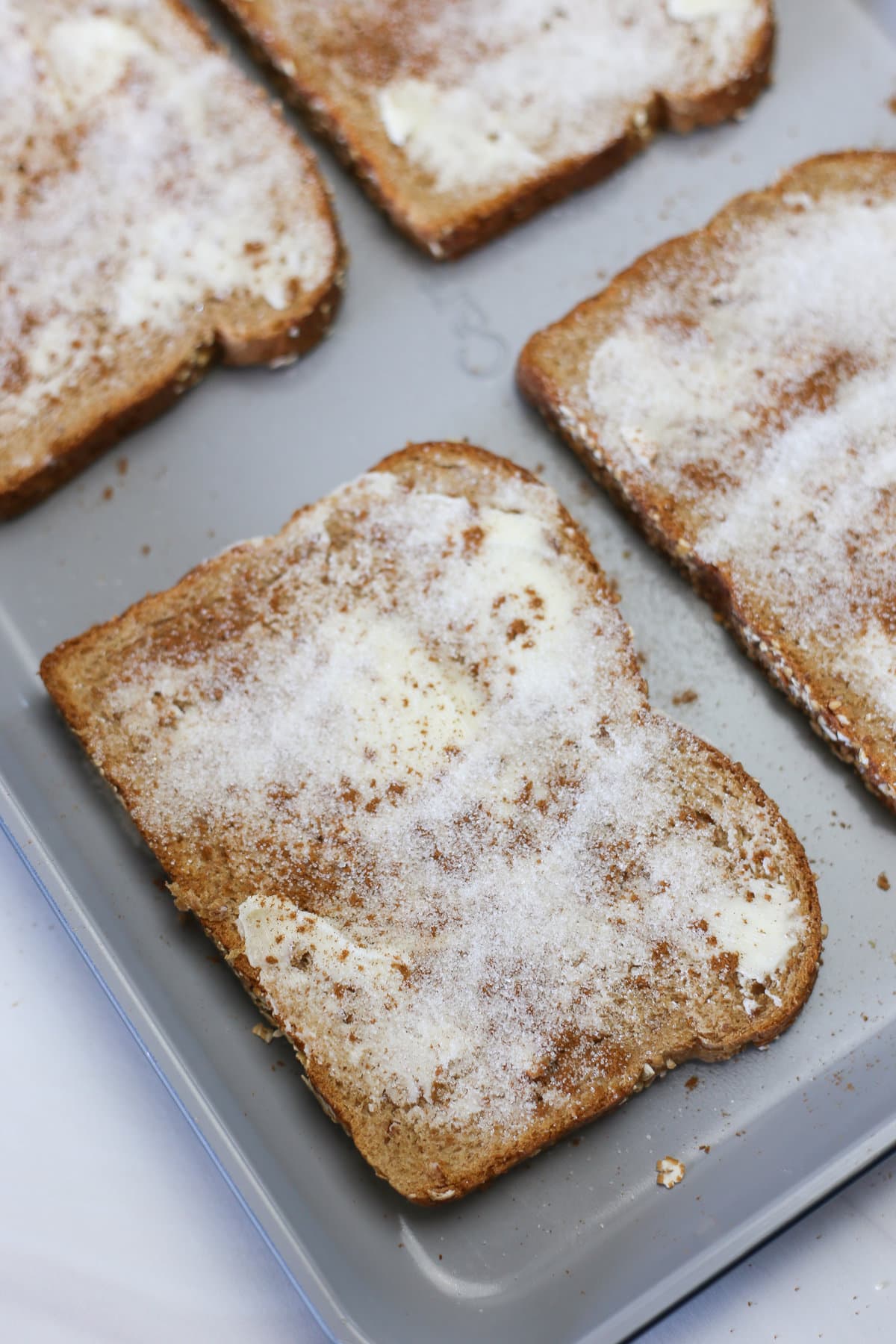 Bread with butter, cinnamon, and sugar on it. 