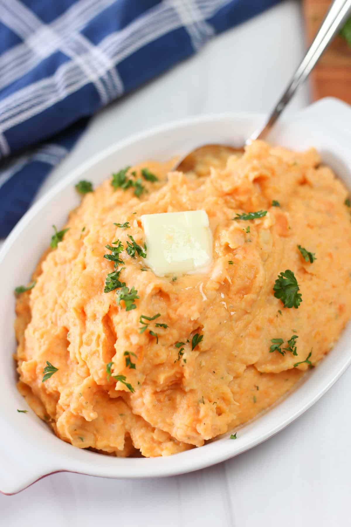 Healthy mashed potatoes with parsley and butter on top.