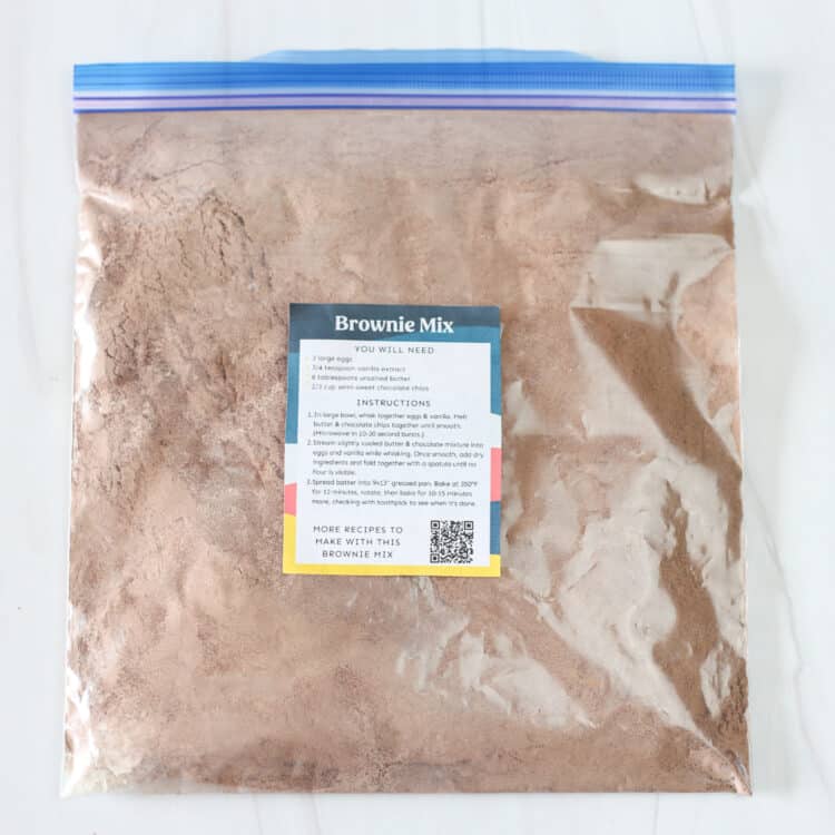 Brownie mix ingredients in a freezer bag with instruction tag taped on it.