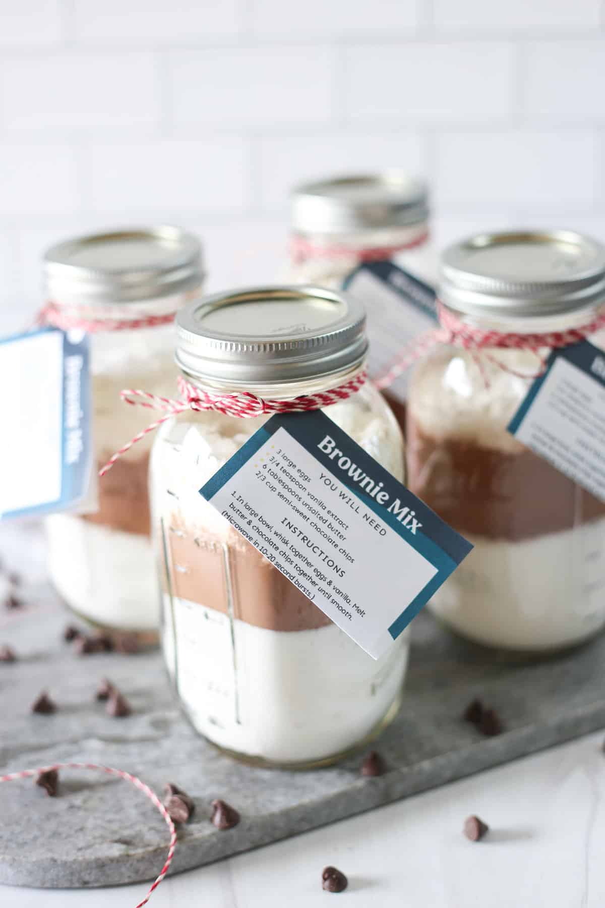 Homemade brownie mix in jars with labels attached.