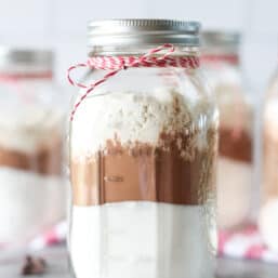 Homemade brownie mix in a large mason jar.