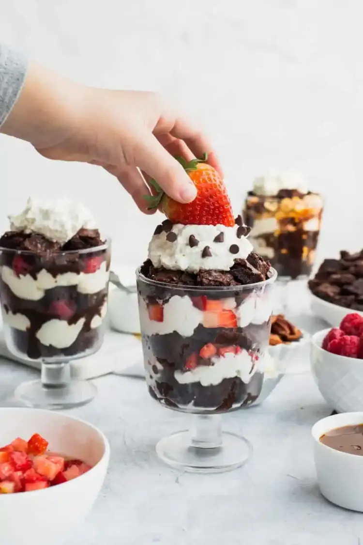 Brownie parfaits in glass dessert cups with different toppings on each.