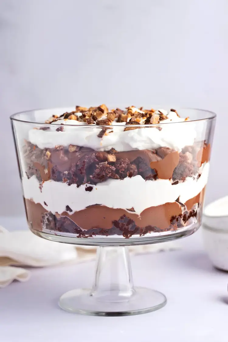 Death by Chocolate trifle with layers of brownie, whipped cream, pudding, and crushed candy bars.