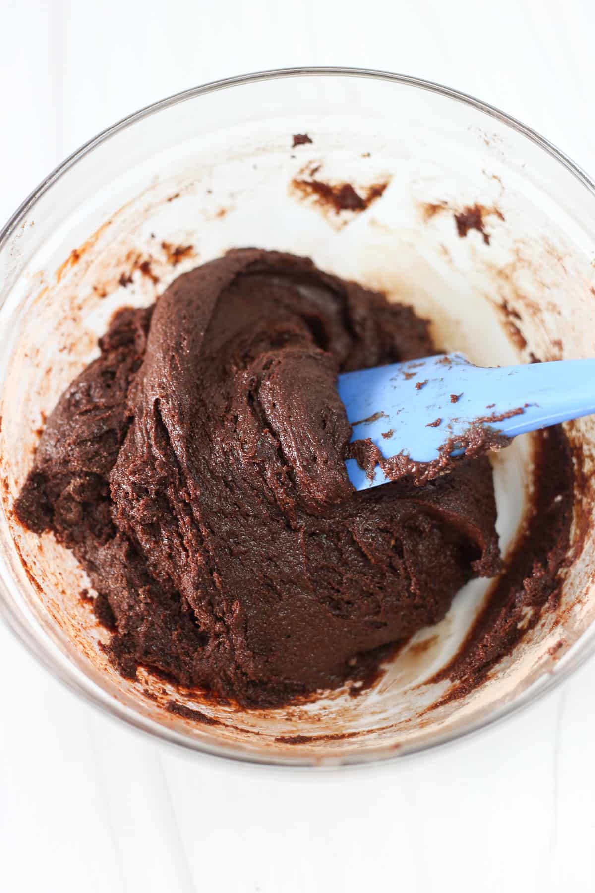 Thriving Home Double Chocolate Brownie batter mixed together in a glass bowl with a spatula.