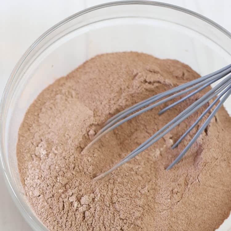 Dry brownie mix in a bowl with a whisk.
