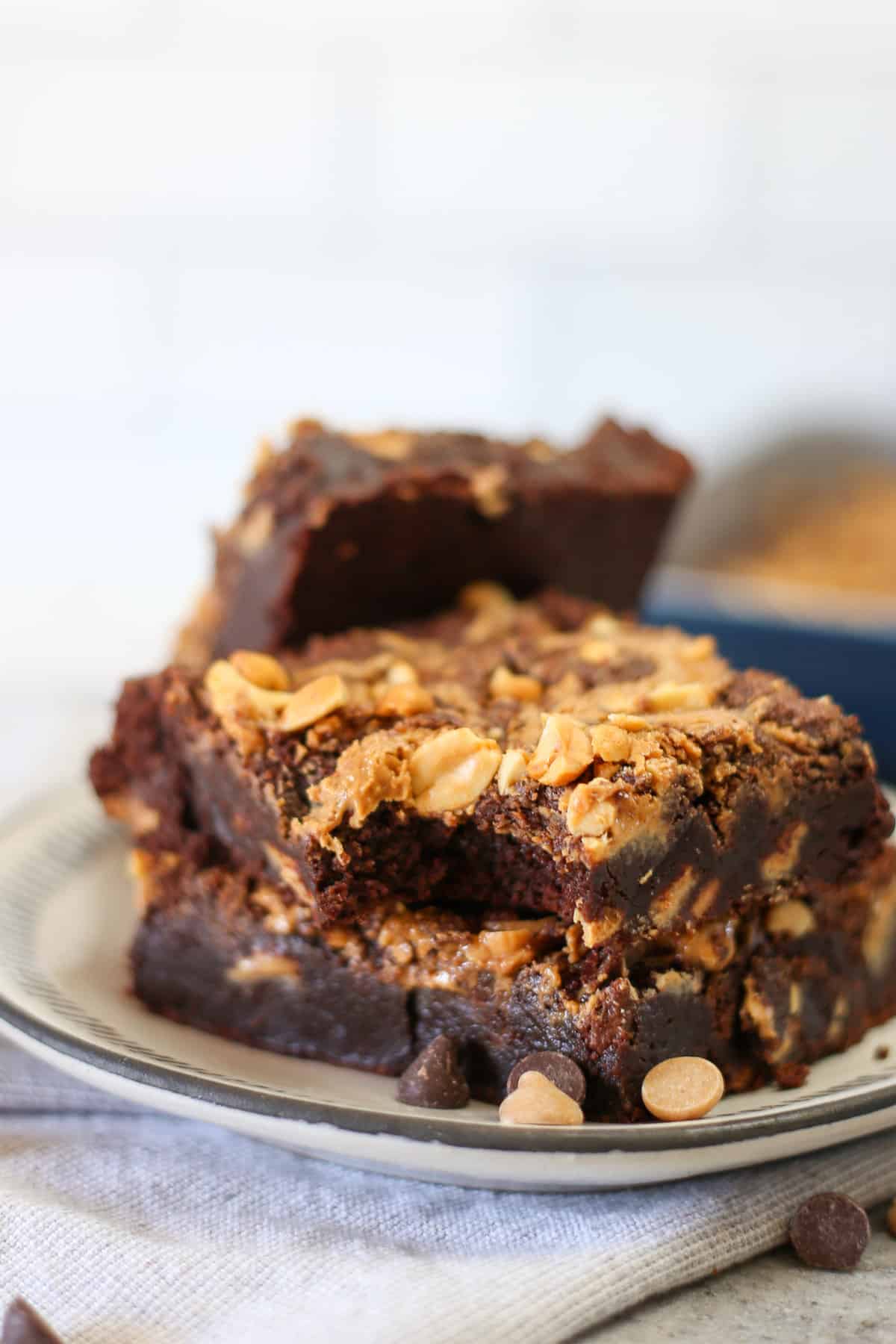 A stack of peanut butter swirl brownies on a plate.