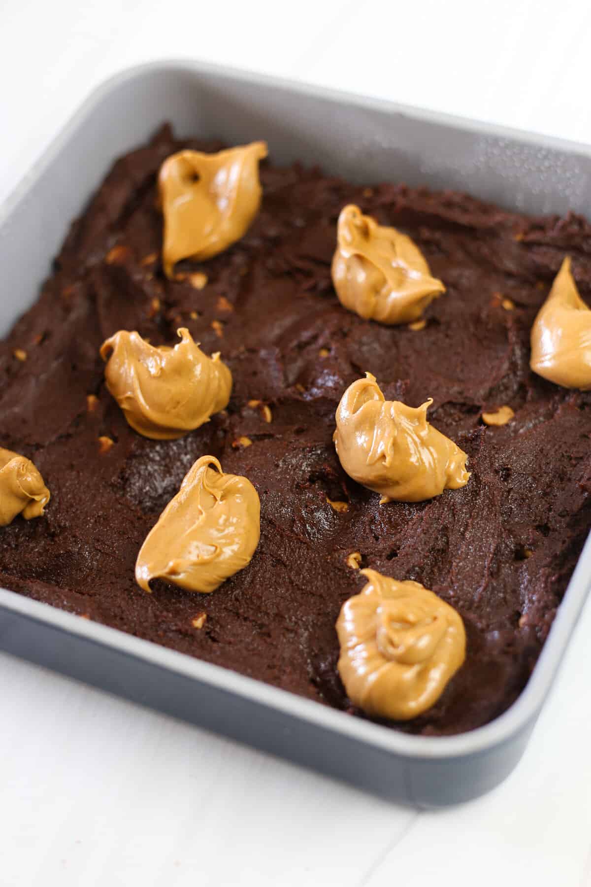 Brownie mix with dollops of peanut butter on top. 