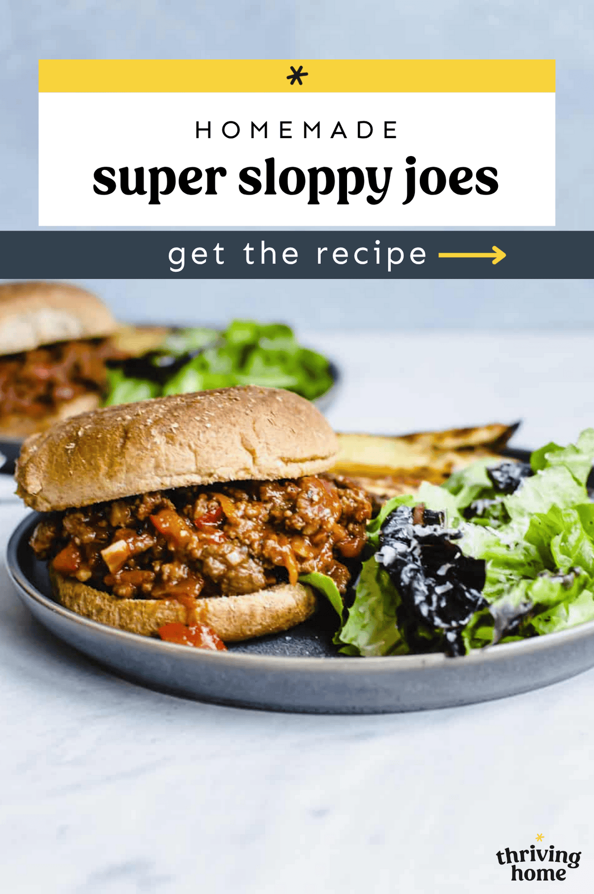 Sloppy Joe sandwich on a plate with a side salad.