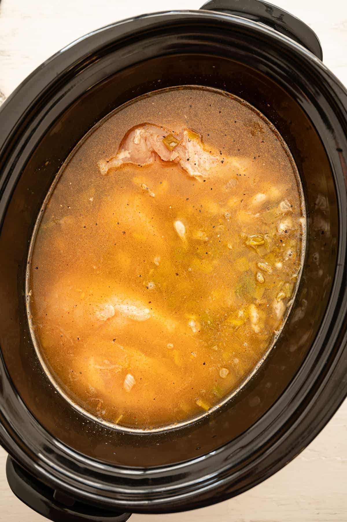 White chicken chili ingredients in a slow cooker.