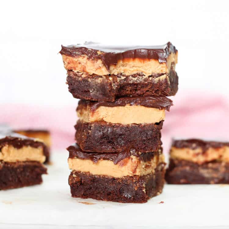 Three buckeye brownies stacked up and one on either side of the stack.