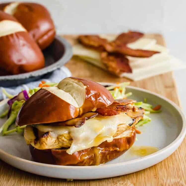 Grilled chicken breast on a pretzel bun with melted cheese, bacon, and a honey Dijon drizzle.