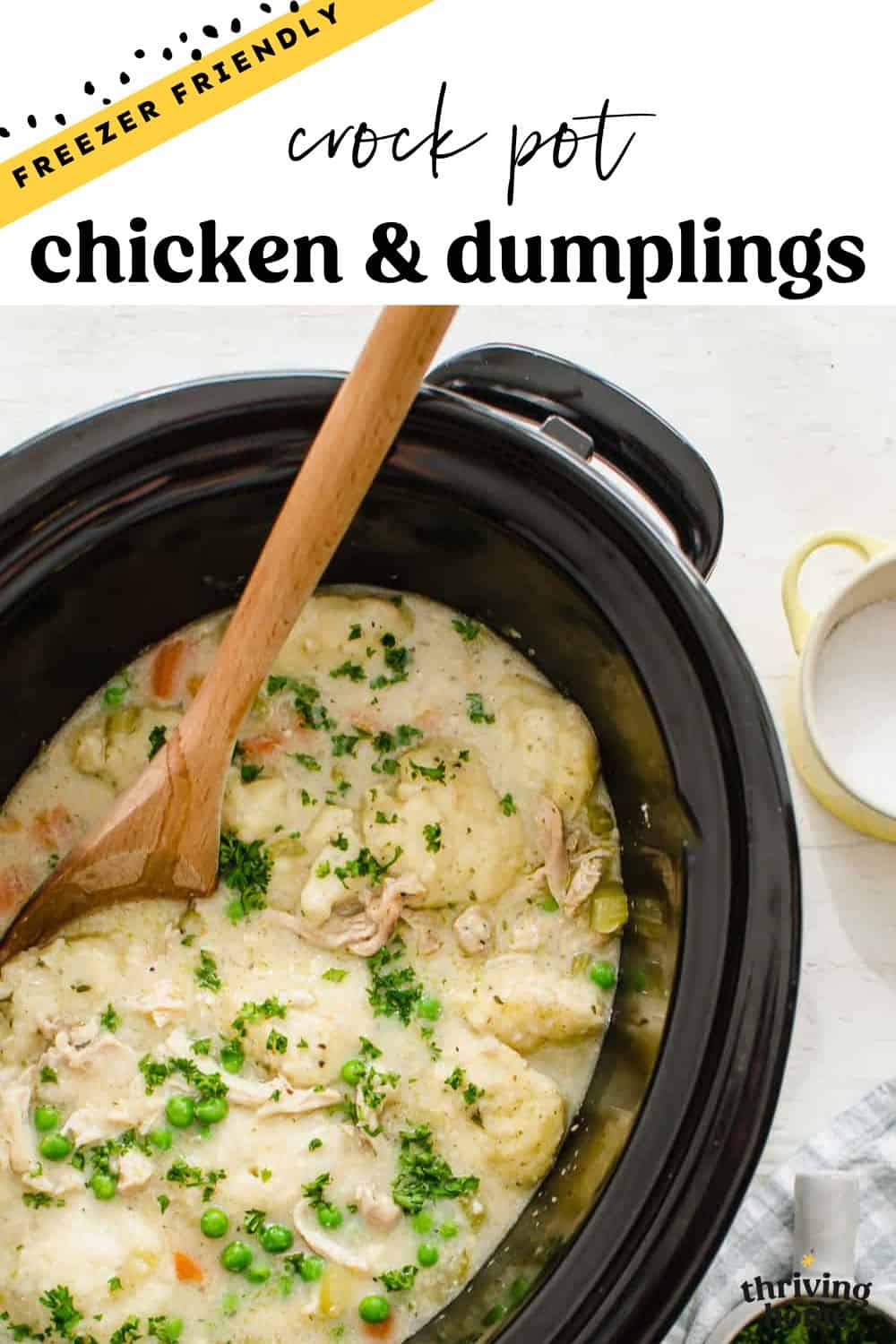 Chicken and dumplings in a slow cooker with a spoon.