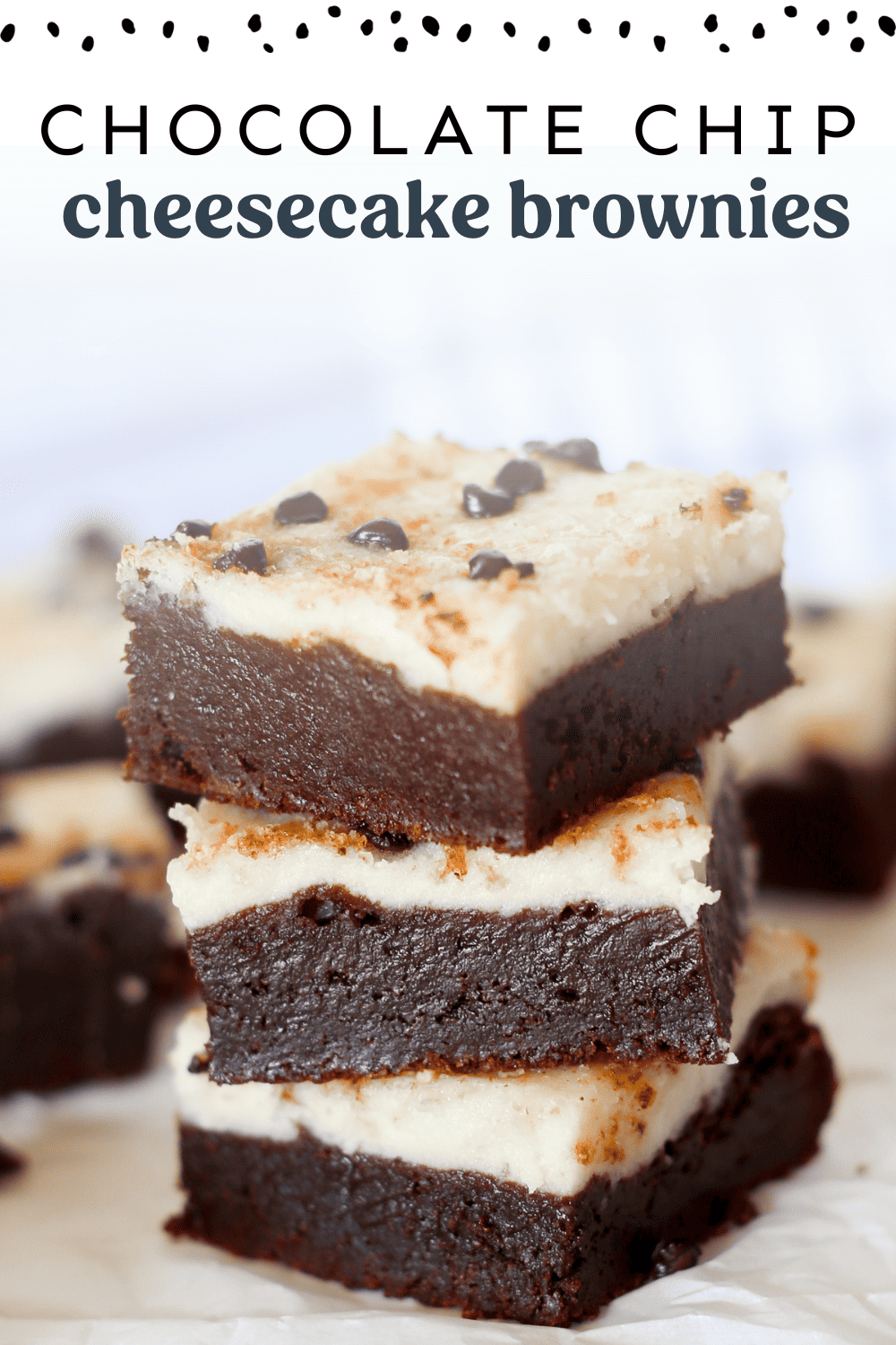Chocolate chip cheesecake brownies stacked on top of each other.