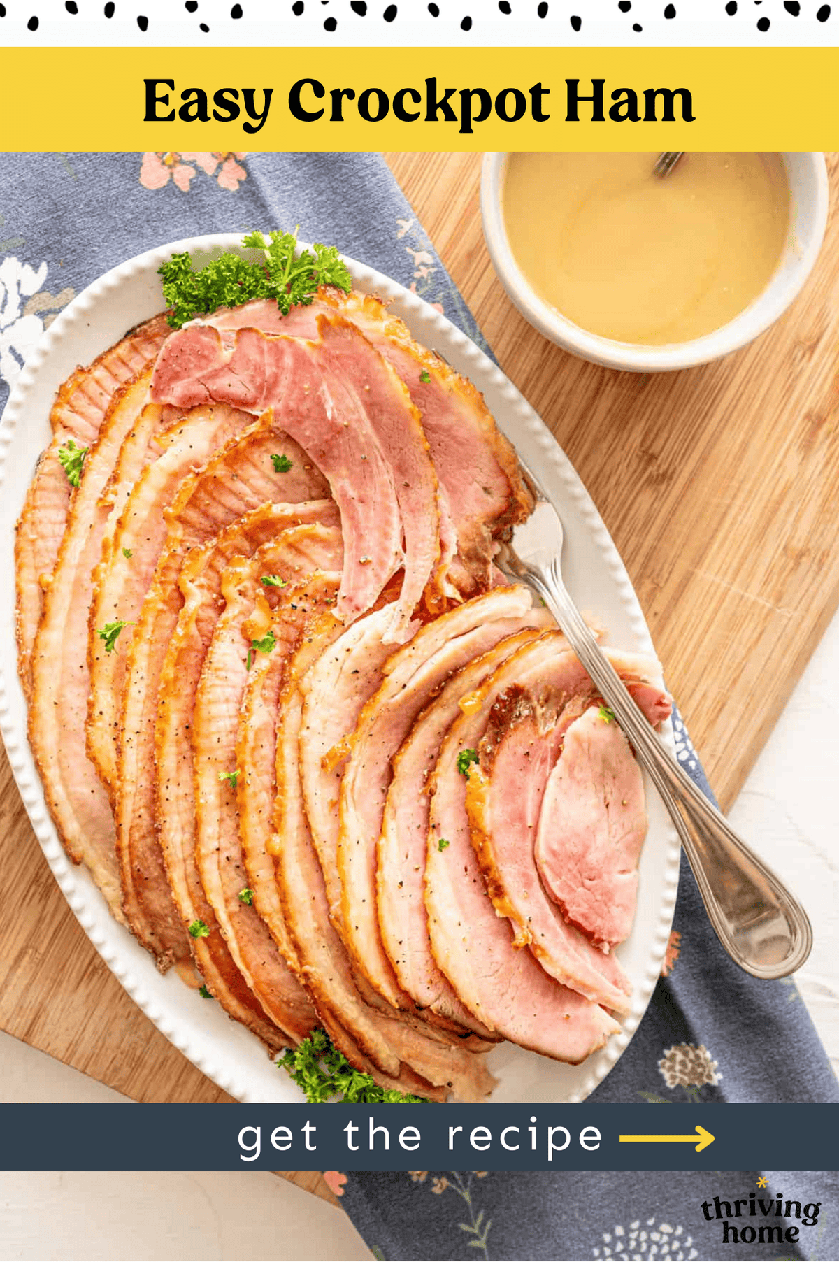 Sliced ham on a platter with a fork.