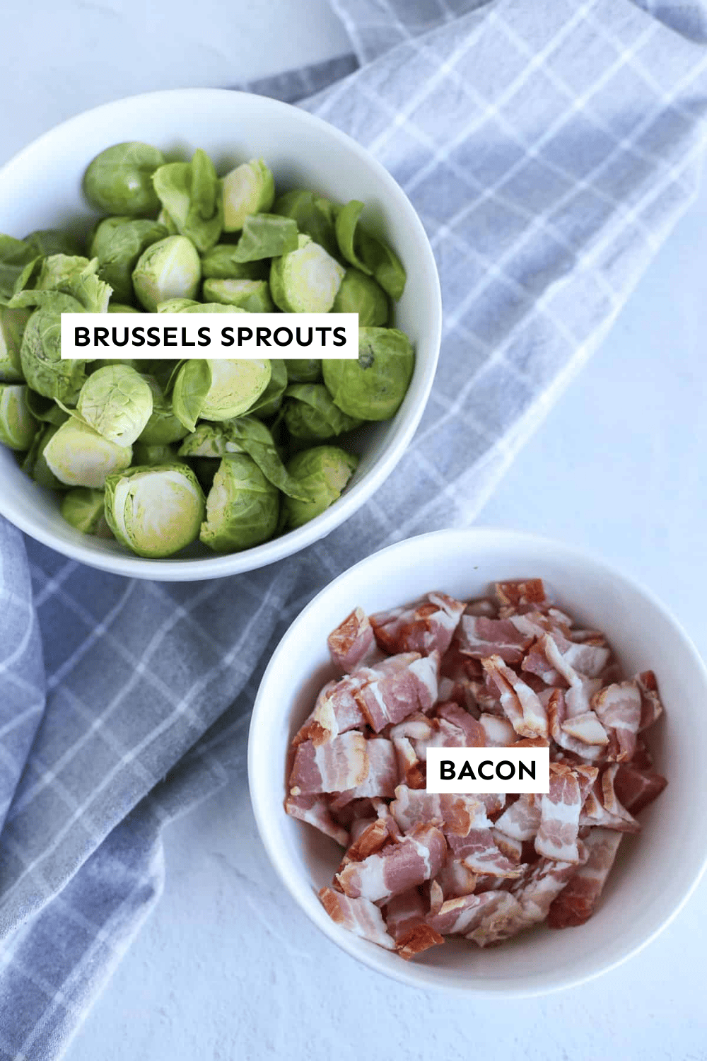 A bowl of chopped Brussels sprouts and a second bowl with chopped bacon.