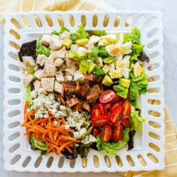 Cobb salad on a square platter.