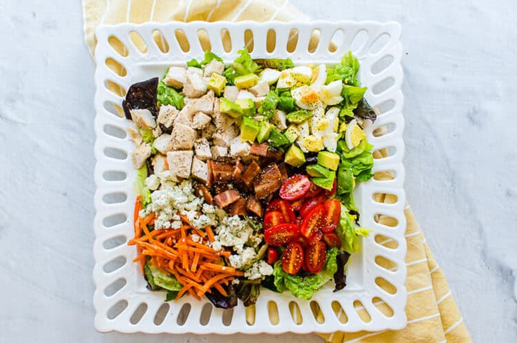 Cobb salad on a square platter.