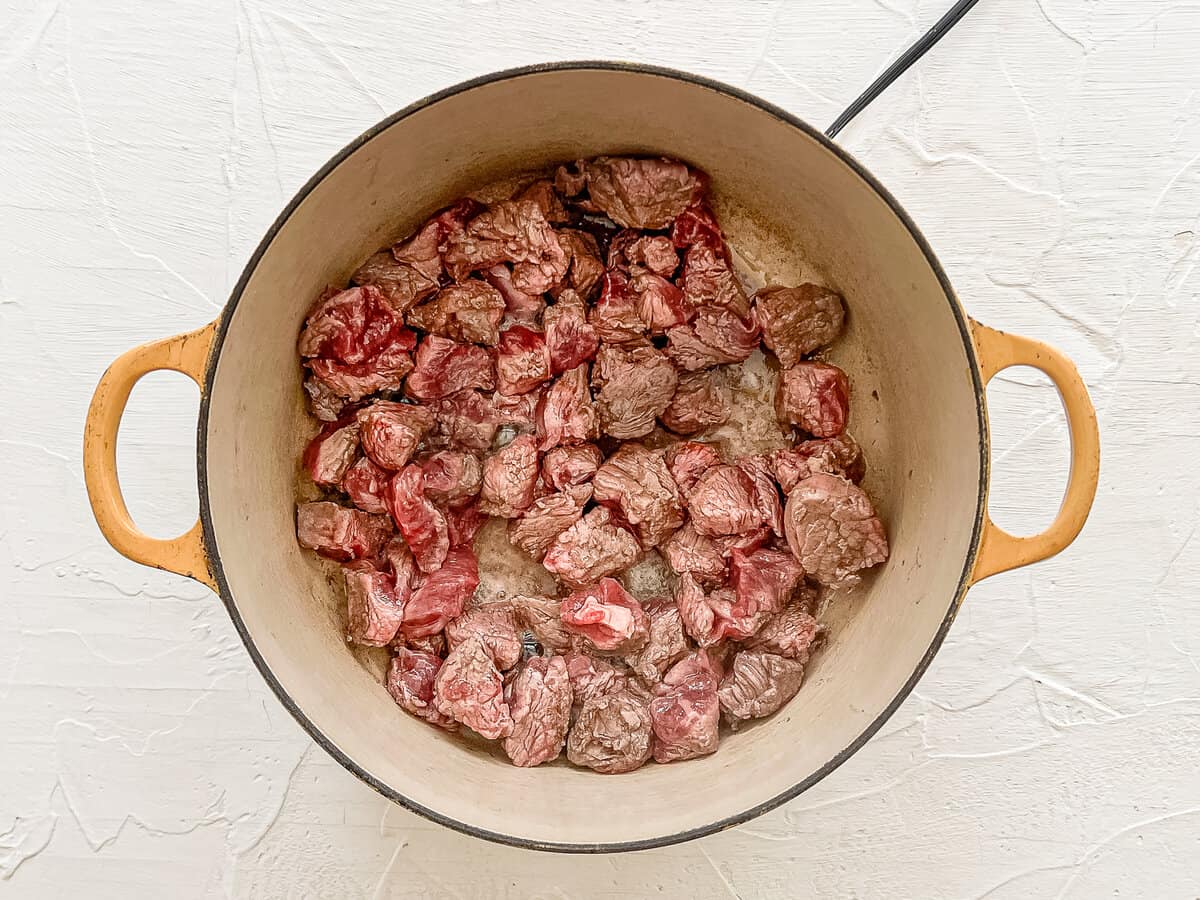 Stew meat in a dutch oven to be cooked for steak chili.