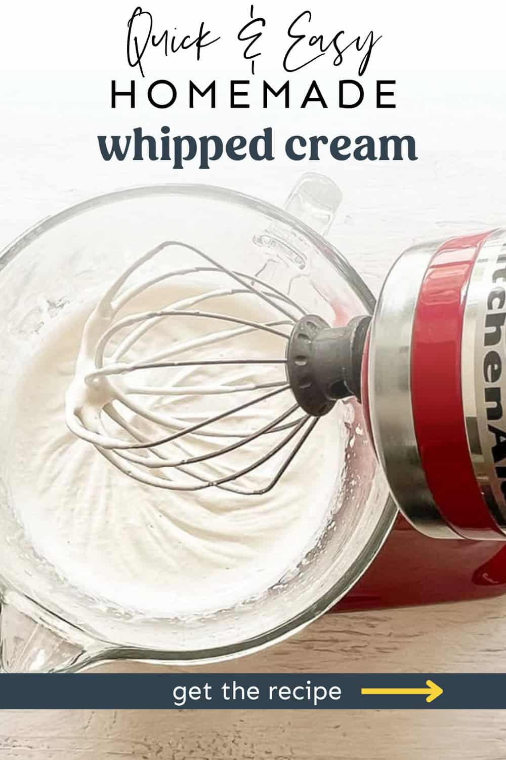 Red Kitchenaid mixer with homemade whipped cream on the whisk attachment and in the mixing bowl.