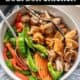 bowl of chicken and stir fry veggies with bourbon sauce on top.