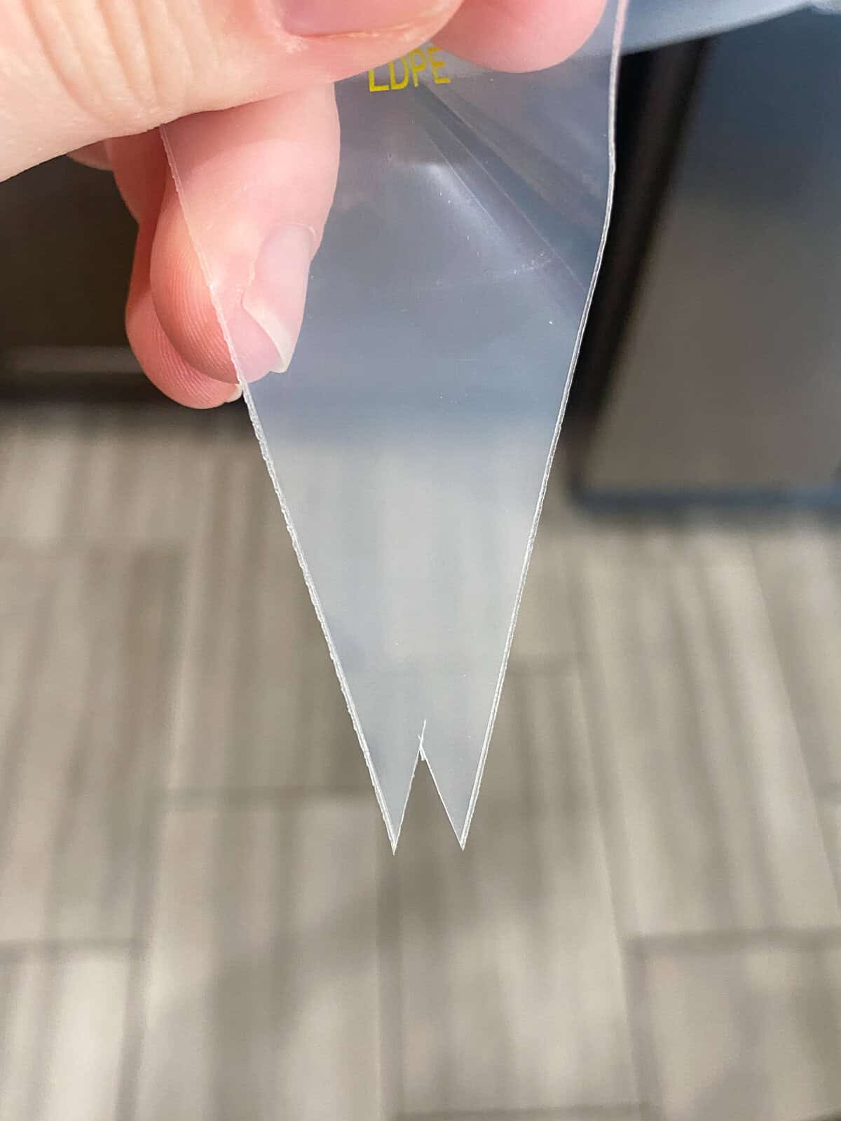 The tip of a piping bag cut out leaving a triangle space. 