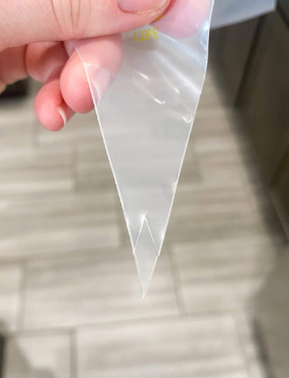 The tip of a piping bag cut as a triangle. 